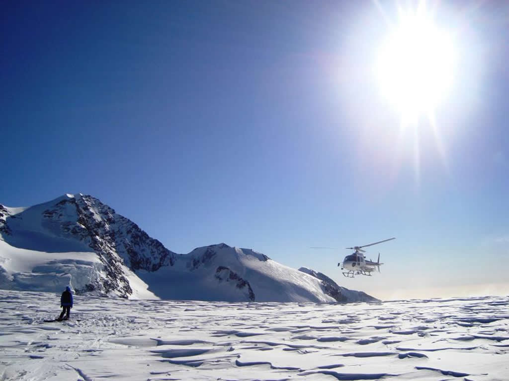 heli-skiing in deep powder in the grand paradisco national park, aosta