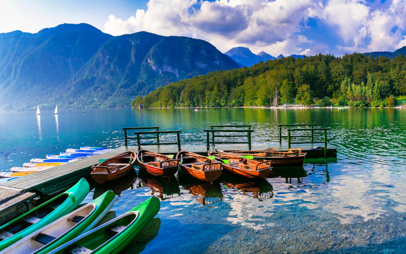 boats on lake bled with julian alps in the background