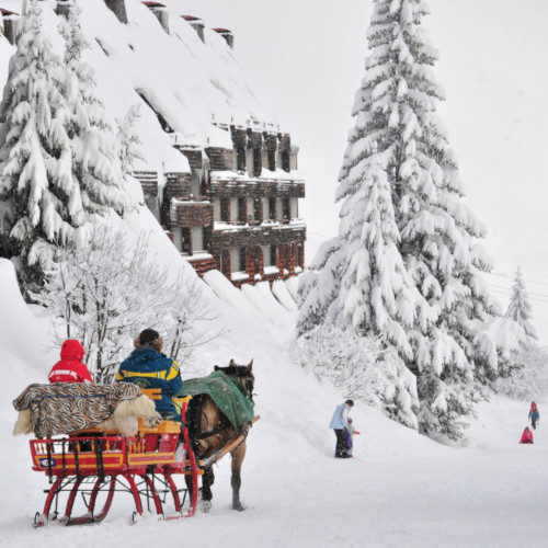 horse drawn sleigh and children playing avoriaz ski resort