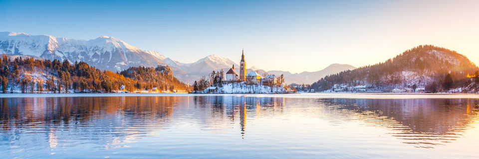 lake bled surrounded by julian alps covered in snow