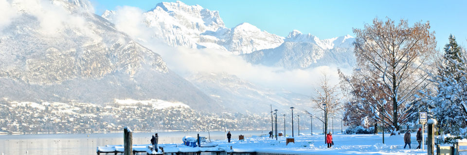 lake annecy in winter covered in snow