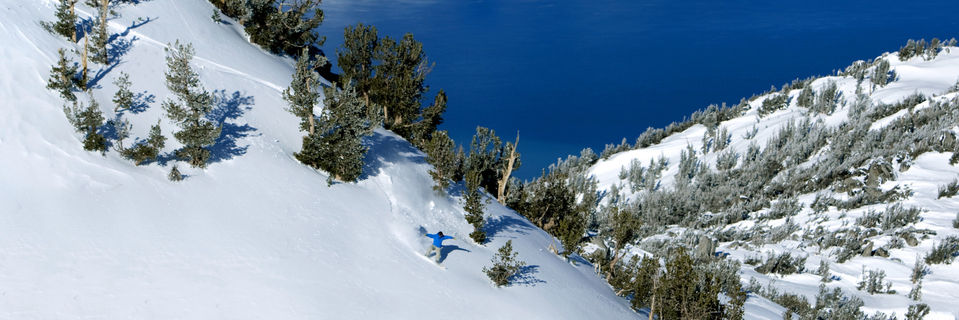 snowboarder at heavenly ski resort with lake tahoe