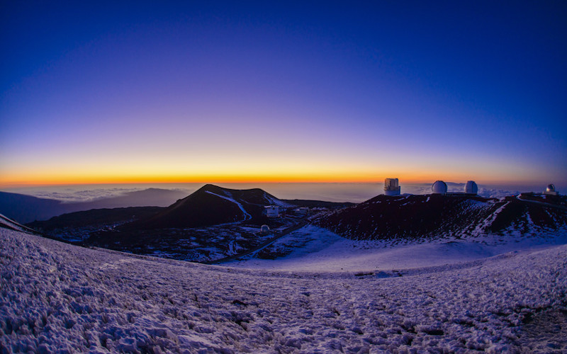 sunrise over a snow capped mauna kea hawaii