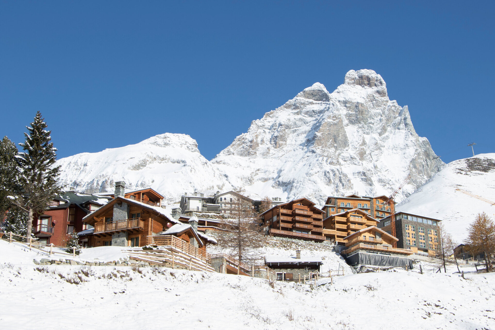 apartments in cervinia with the matterhorn in the background covered in snow