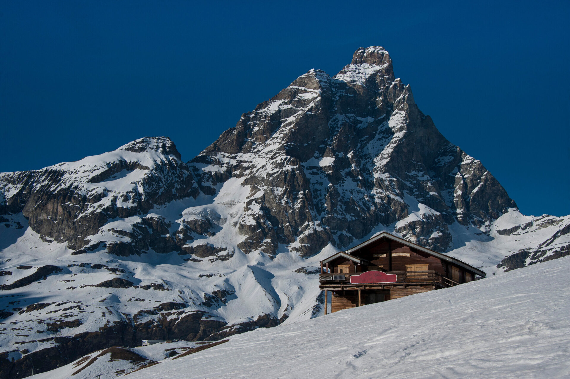 chalet in cervinia covered in snow facing the matterhorn