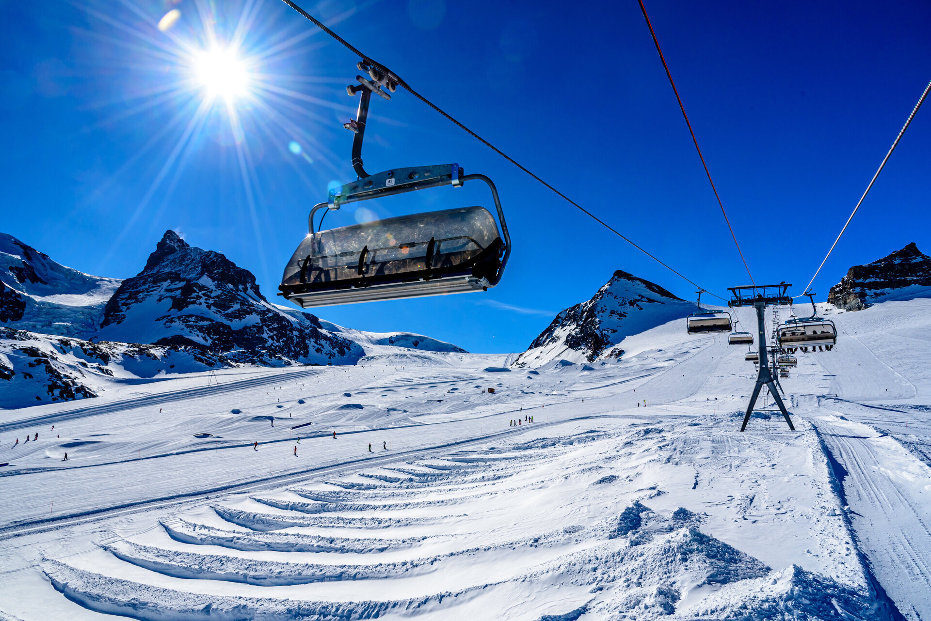 skiers on the slopes in cervinia on a sunny day
