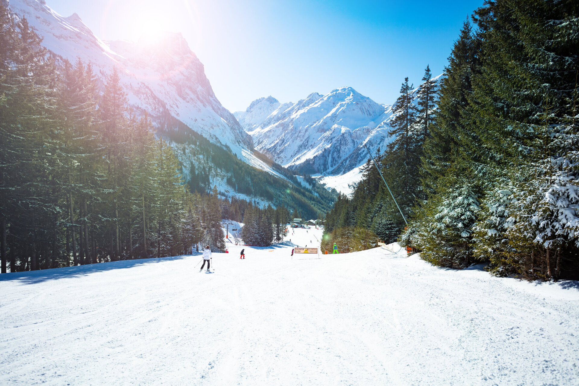 skiing down a piste in les arcs with snow covered trees